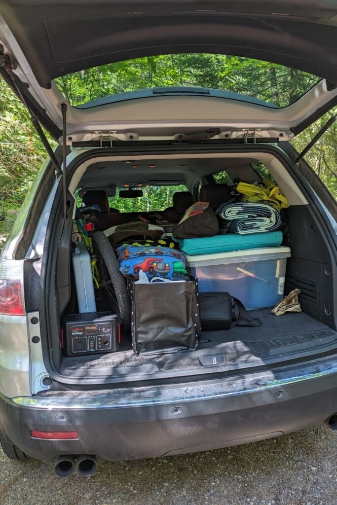 a pile of camping gear in a vehicle