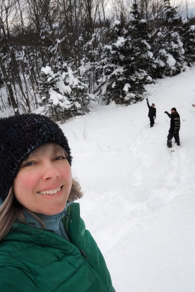 Smiling family hiking in the deep snow