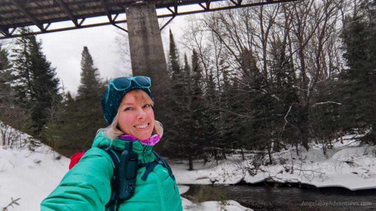 Smiling Woman Showing the benefits of winter hiking