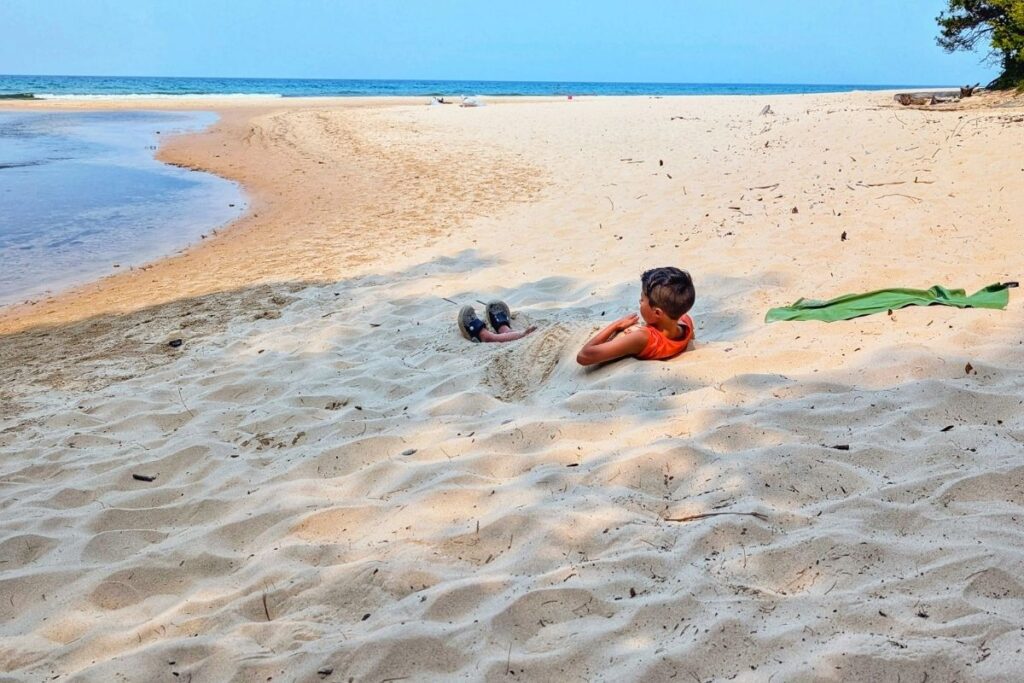 boy buried in sand Pictured Rocks Michigan